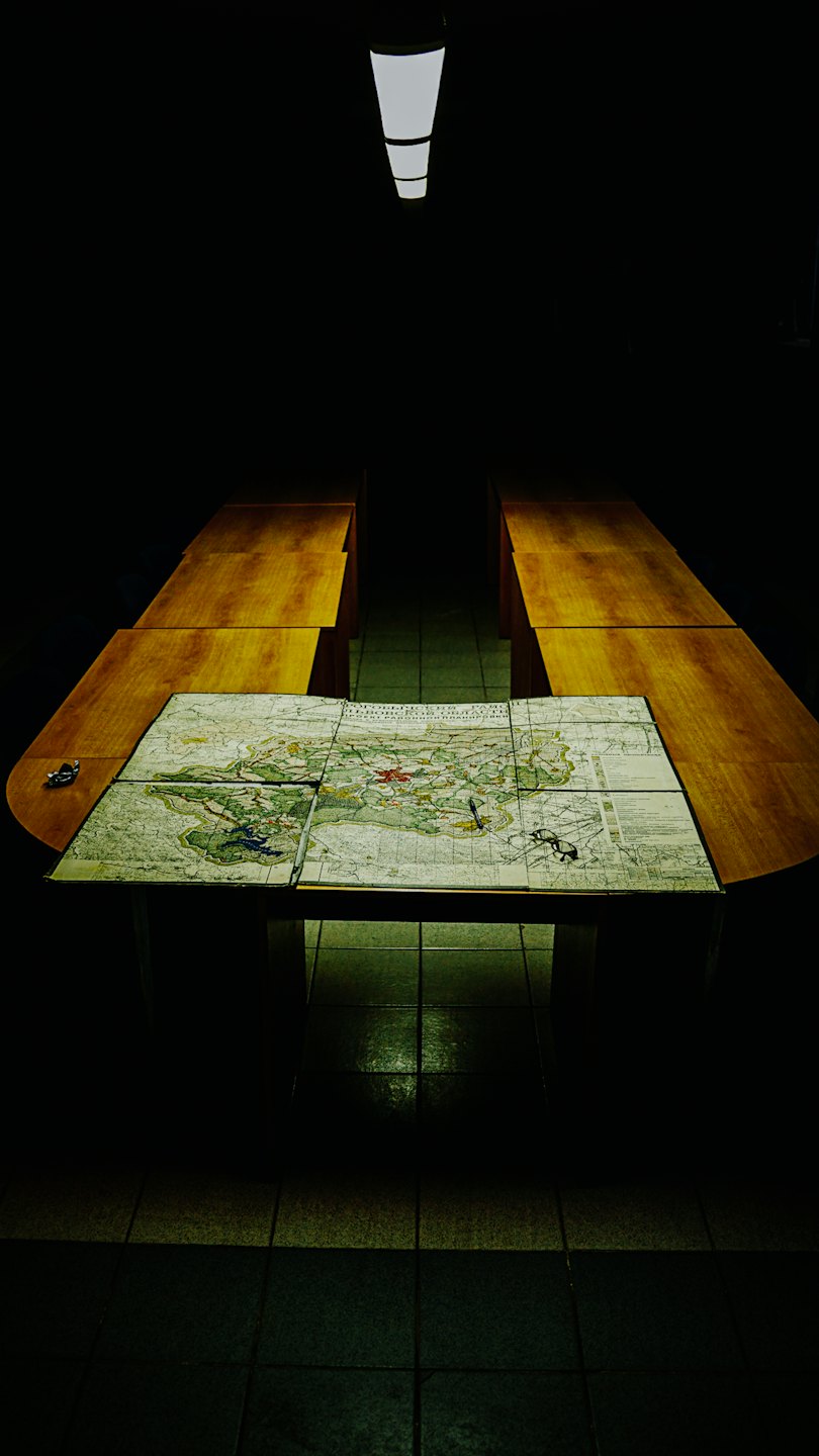 A vintage map is spread out on a wooden table.